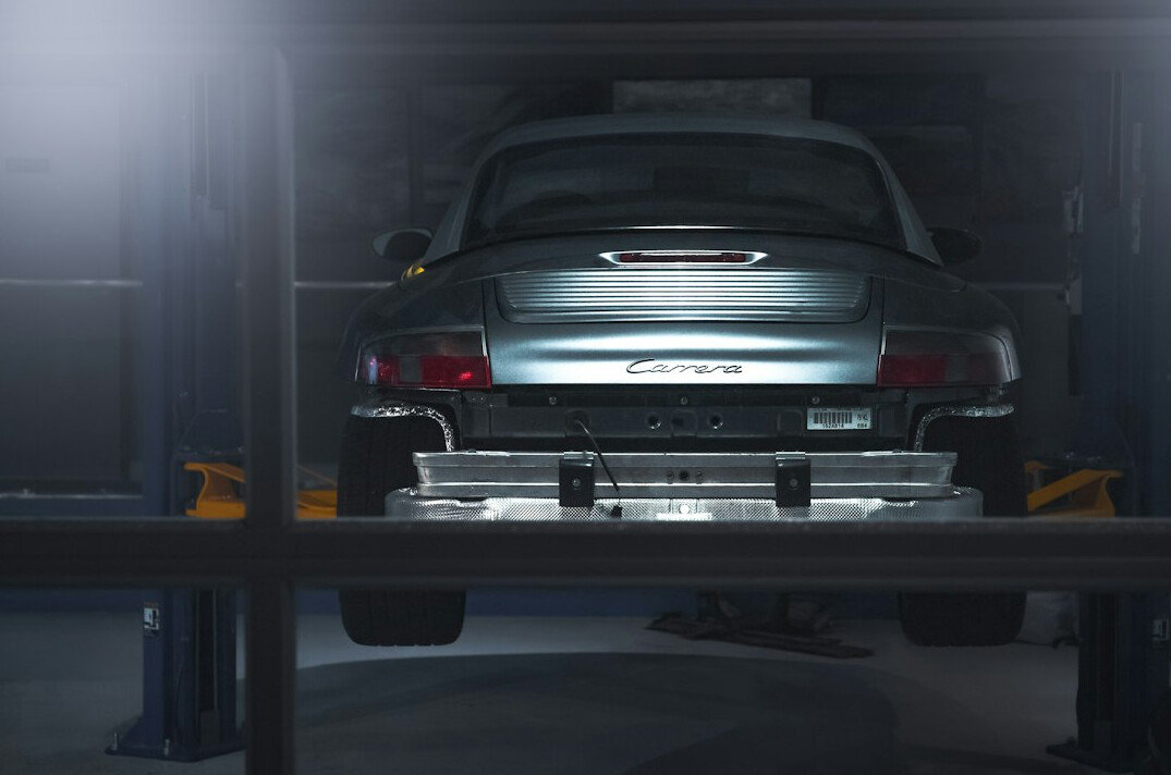 Car lifted on a hydraulic lift in a garage